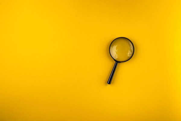 best background check services 2019 magnifying glass on yellow background